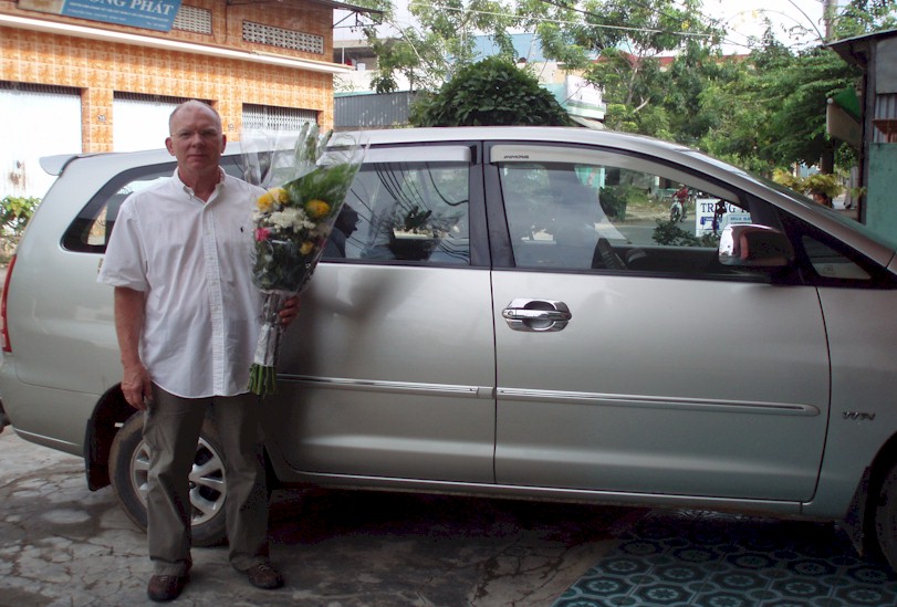 Dan Cornell in Hong Ngu, Vietnam after buying flowers at the marketplace to put where Carl died.