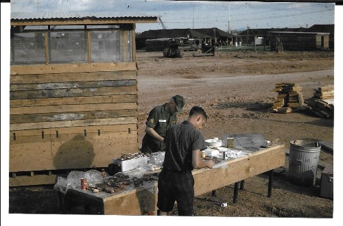 Behind the latrine preparing lunch?  The Sergeant was our Personnel Sergeant. Dec 1966.